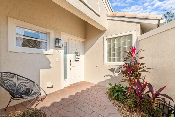 Doorway to property with a patio area