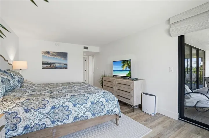 Bedroom featuring access to outside and light wood-style floors - Virtually Edited Image