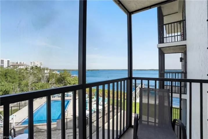 Side Balcony off of Dining Area featuring view of pool, and view of San Carlos Pass - Virtually Edited Image