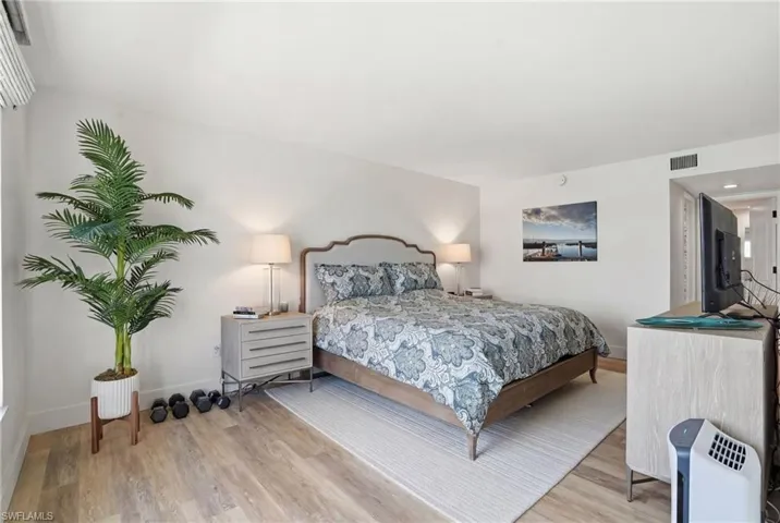 Bedroom featuring light wood finished floors and baseboards - Virtually Edited Image