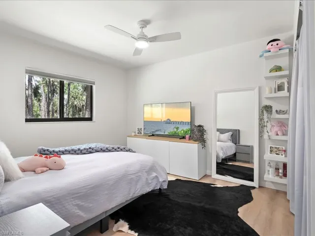Bedroom featuring light wood-type flooring and a ceiling fan