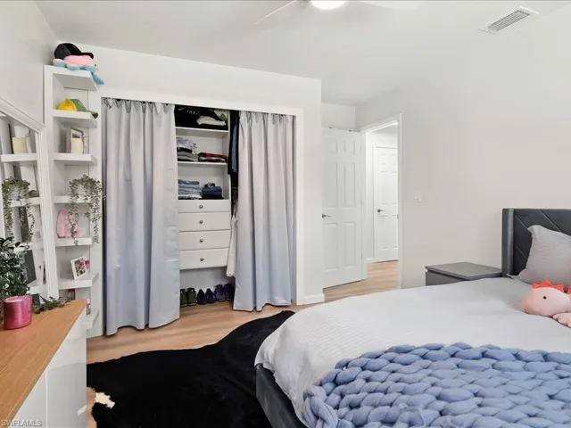 Bedroom featuring light wood-style flooring, a closet, and a ceiling fan