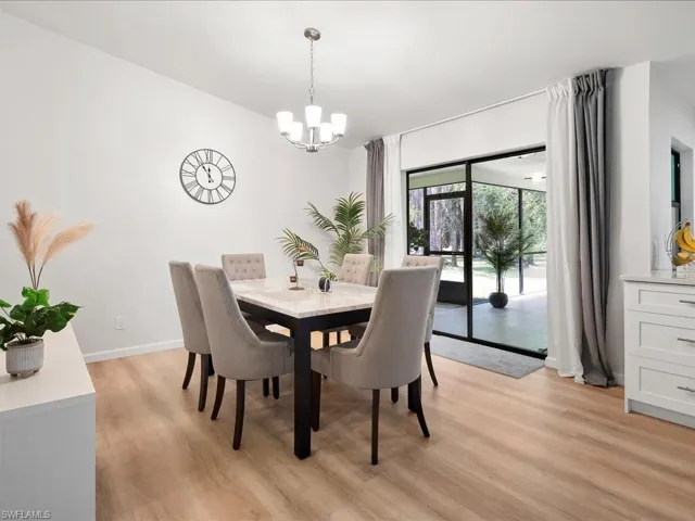 Dining room with a chandelier and light wood-type flooring