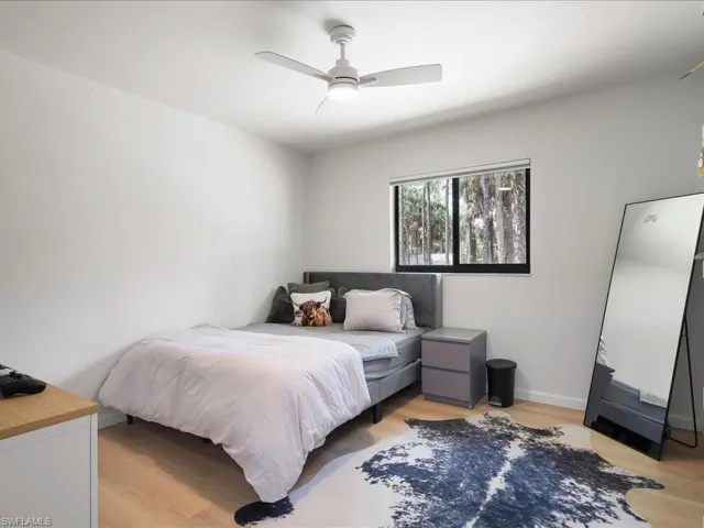 Bedroom with light wood-style floors and ceiling fan