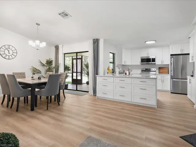 Dining room with a chandelier and light wood finished floors