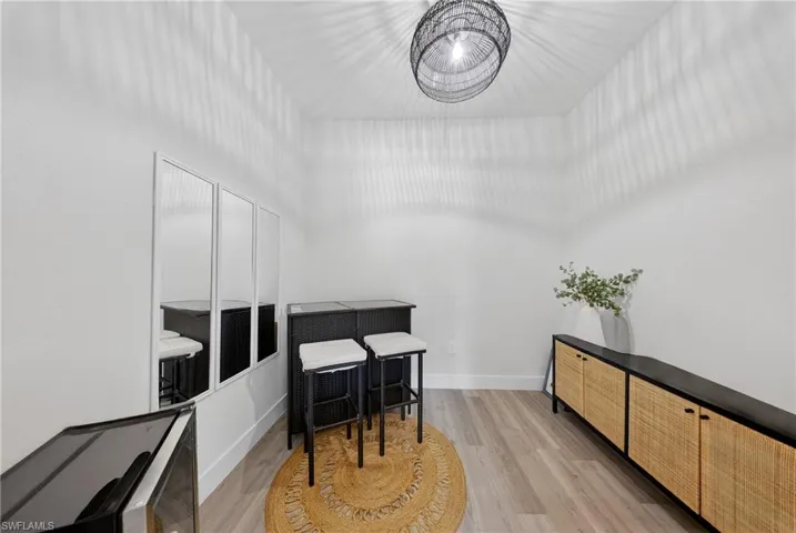 Office area with light wood-style flooring and baseboards