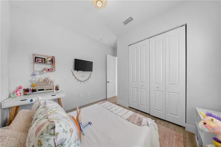 Bedroom featuring light wood-type flooring and a closet