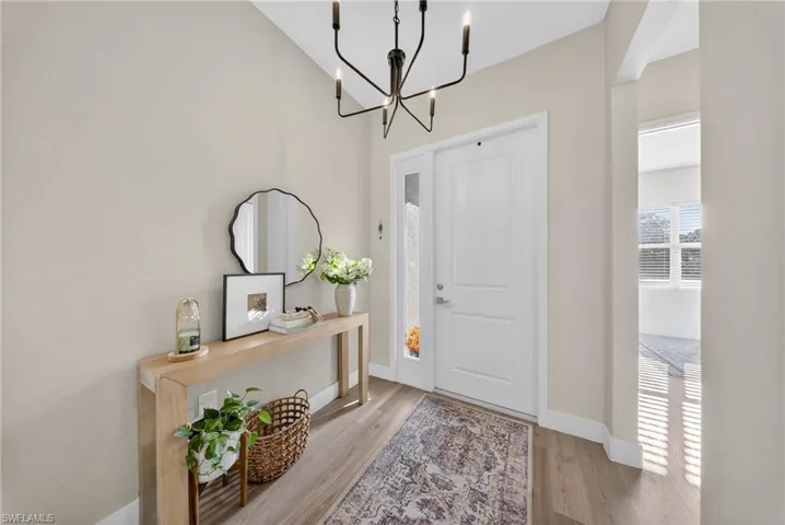 Foyer featuring a chandelier and light wood-style flooring