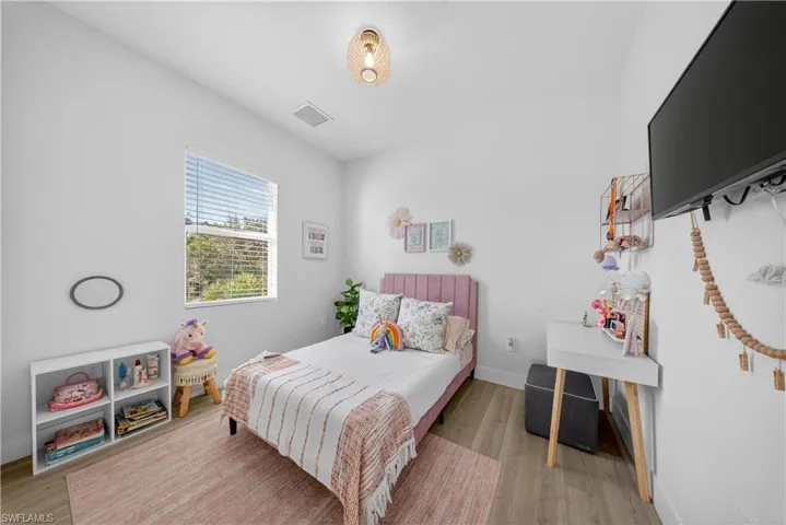 Bedroom featuring light wood-style floors and baseboards