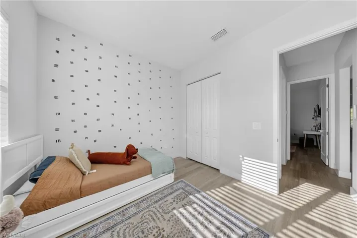 Bedroom with a closet and light wood-style floors