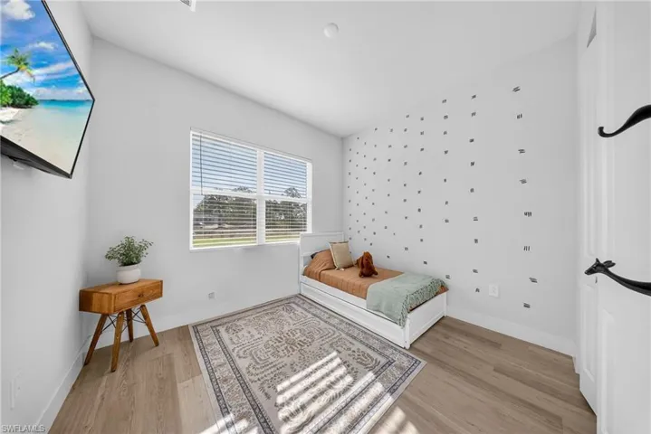 Bedroom featuring light wood finished floors and baseboards