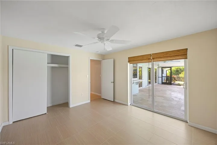 Guest bedroom featuring access to outside lanai, with a closet, and a ceiling fan