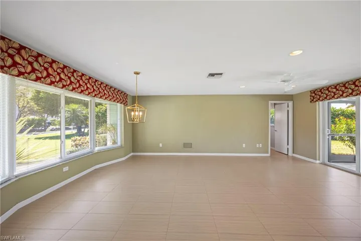 Empty room with recessed lighting, ceiling fan, a chandelier, and light tile patterned floors