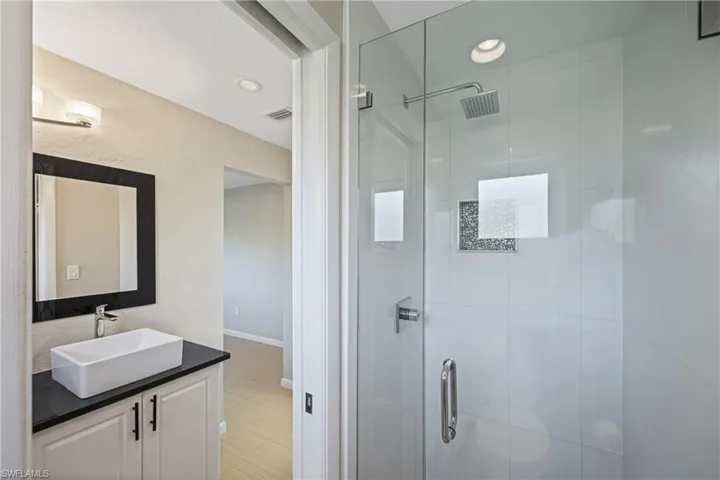 Bathroom featuring vanity, a stall shower, and recessed lighting