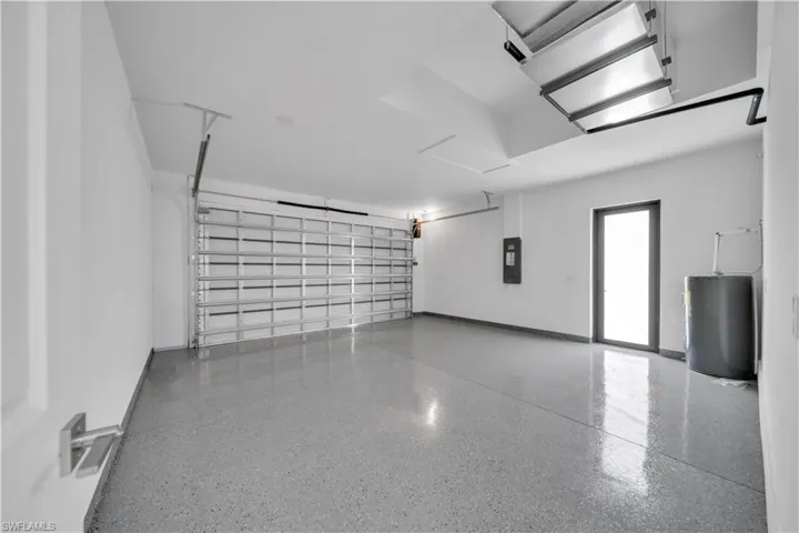 Garage with water heater and electric panel