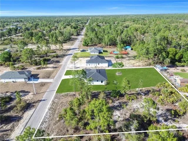 Aerial overview of property's location featuring a forest and property boundaries highlighted
