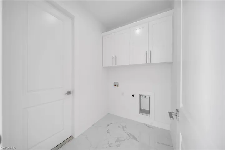 Laundry area featuring light marble finish floors, washer hookup, cabinet space, electric dryer hookup, and gas dryer hookup