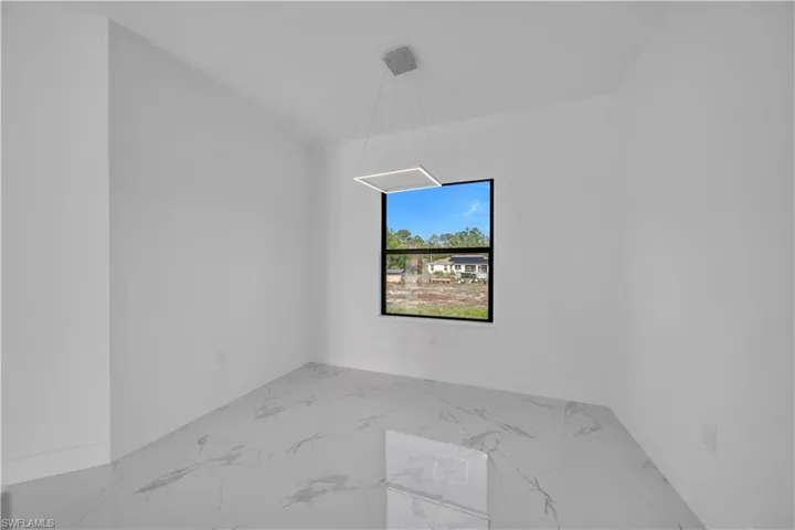 Unfurnished room featuring light marble finish flooring