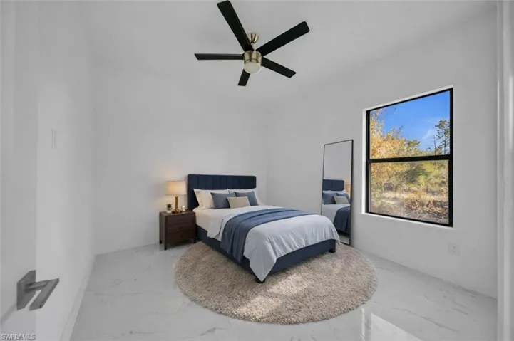 Bedroom with ceiling fan and light marble finish flooring