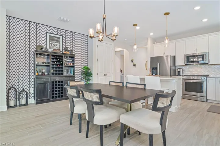 Dining area featuring a chandelier and light wood-type flooring