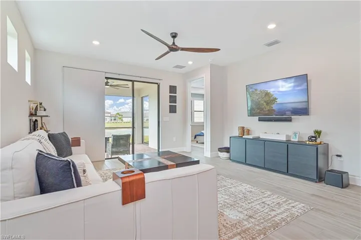Living room featuring ceiling fan and light hardwood / wood-style flooring