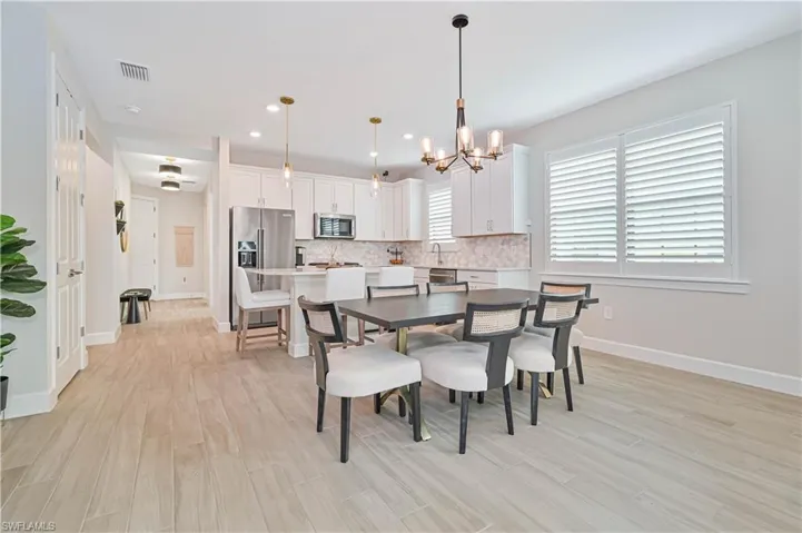 Dining room featuring a notable chandelier and light wood-type flooring