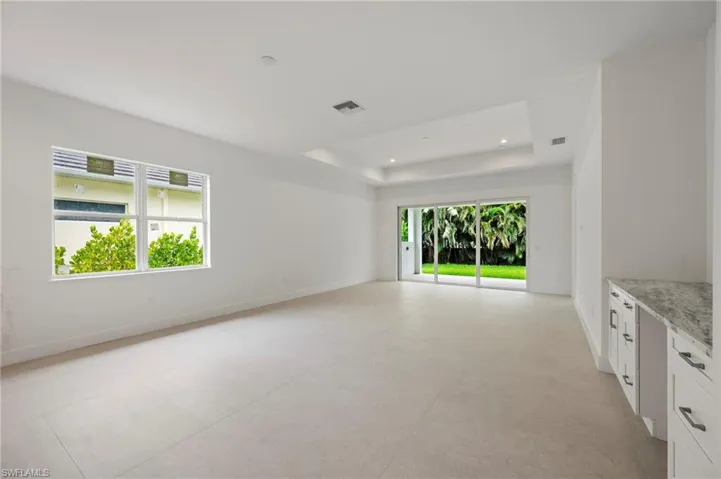 Unfurnished room with concrete flooring and recessed lighting