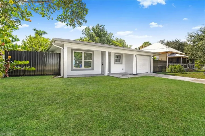 View of front facade with stucco siding, a garage, and concrete driveway
