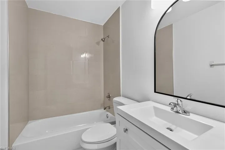 Full bath with vanity and shower / bath combination