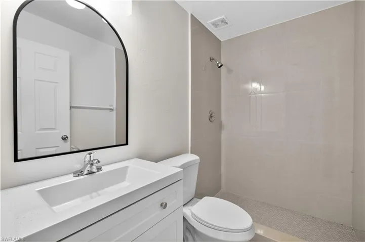 Bathroom with vanity and a tile shower