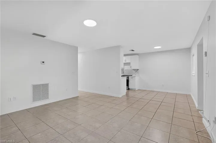 Unfurnished living room featuring light tile patterned flooring and recessed lighting
