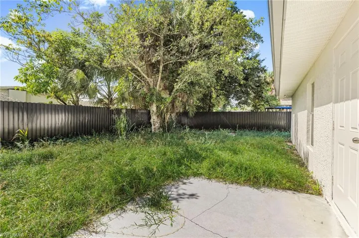 Fenced backyard featuring a patio