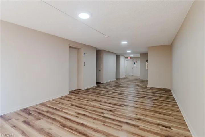 Unfurnished room with recessed lighting, light wood-type flooring, baseboards, and a textured ceiling