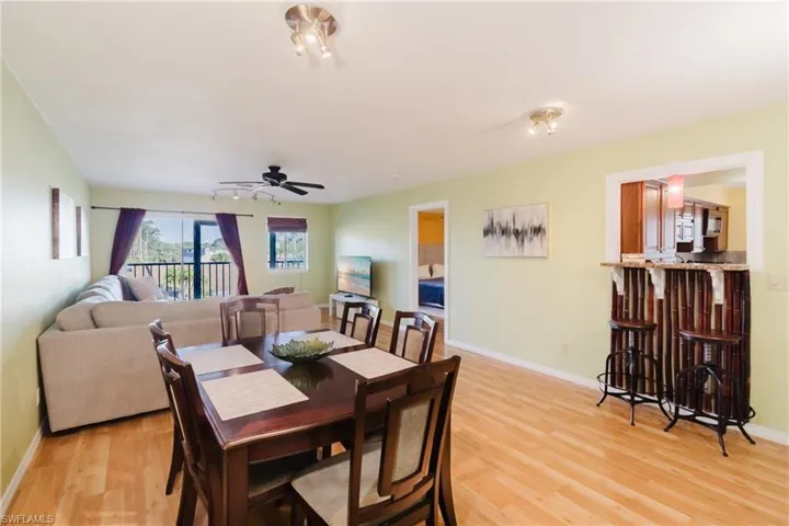 Dining room with baseboards, light wood-style flooring, and a ceiling fan