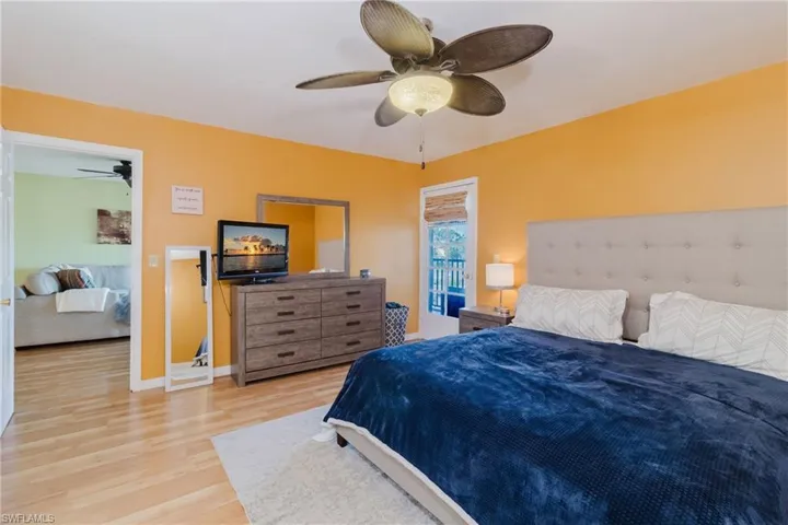 Bedroom with baseboards, light wood-type flooring, and ceiling fan