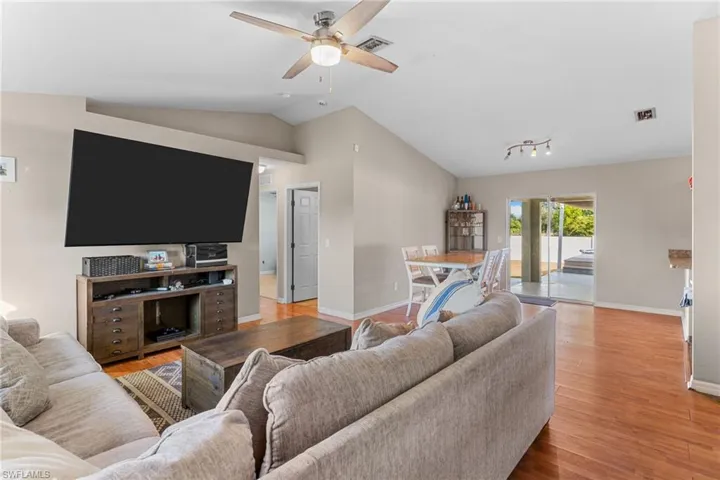 Living room featuring ceiling fan and wood finished floors