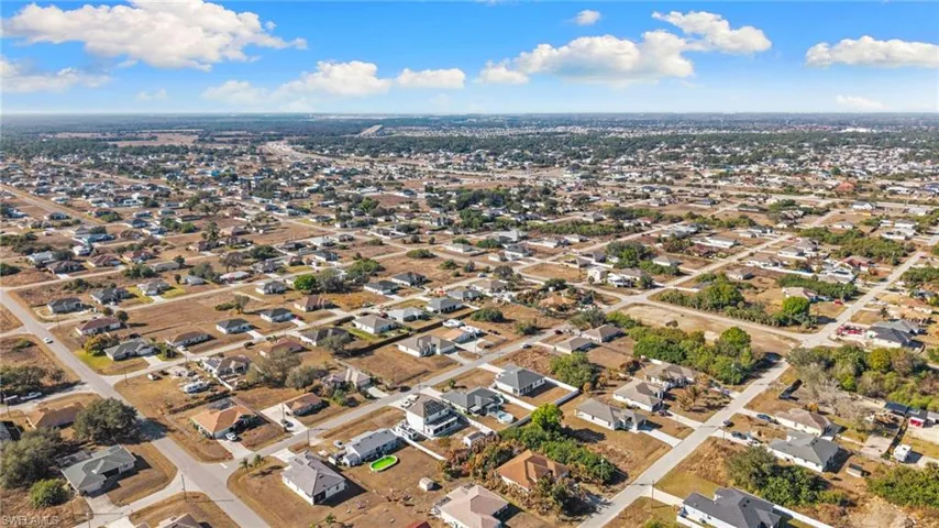 Aerial view of property's location with nearby suburban area