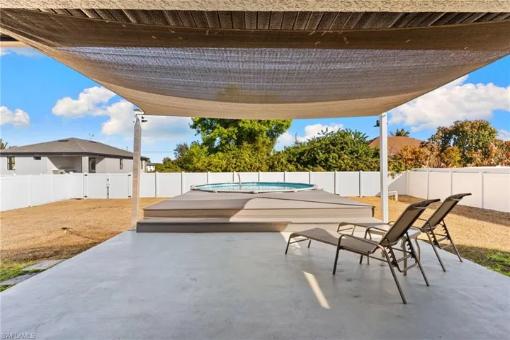 Fenced backyard with a patio area