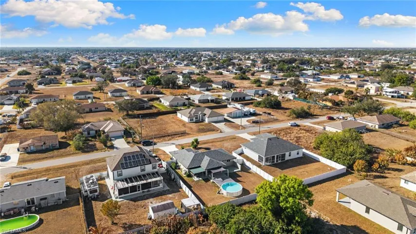 Aerial view of property's location with nearby suburban area