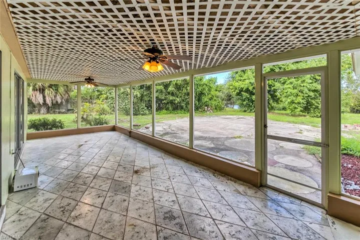 Unfurnished sunroom with ceiling fan