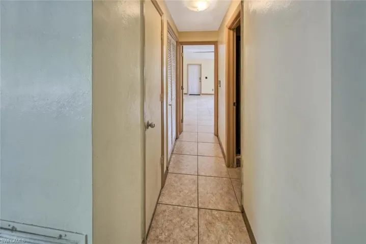 Hall with light tile patterned flooring