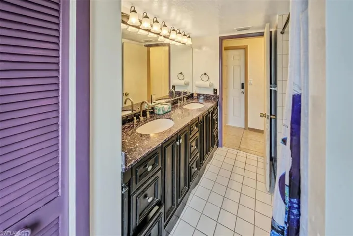 Bathroom with tile patterned flooring and vanity