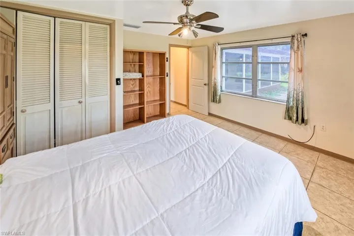 Tiled bedroom with ceiling fan