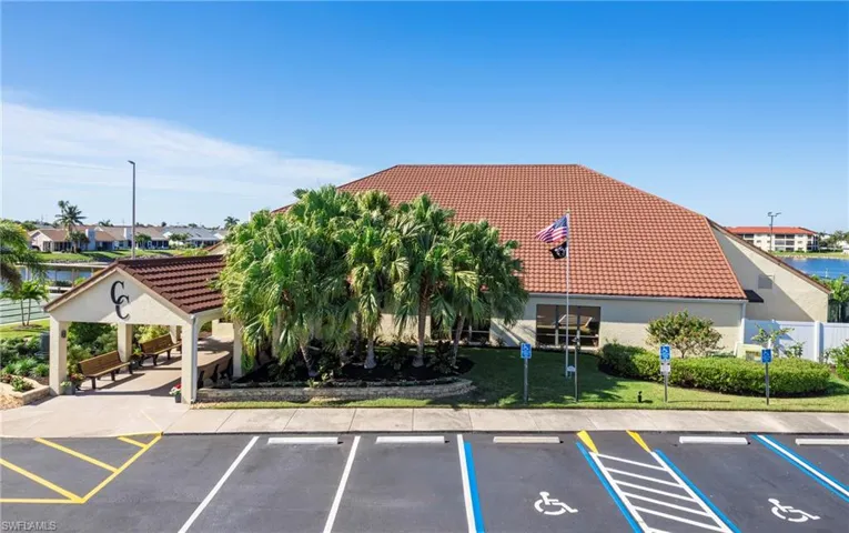 View of property featuring a water view and uncovered parking