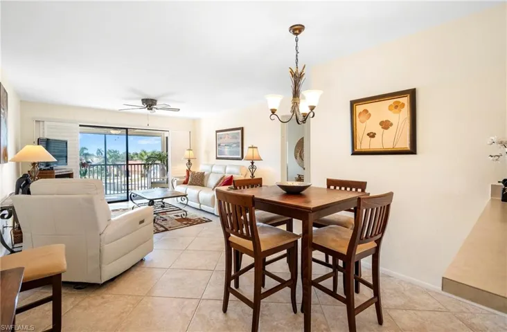 Dining space with a chandelier, ceiling fan, and beautiful tile.