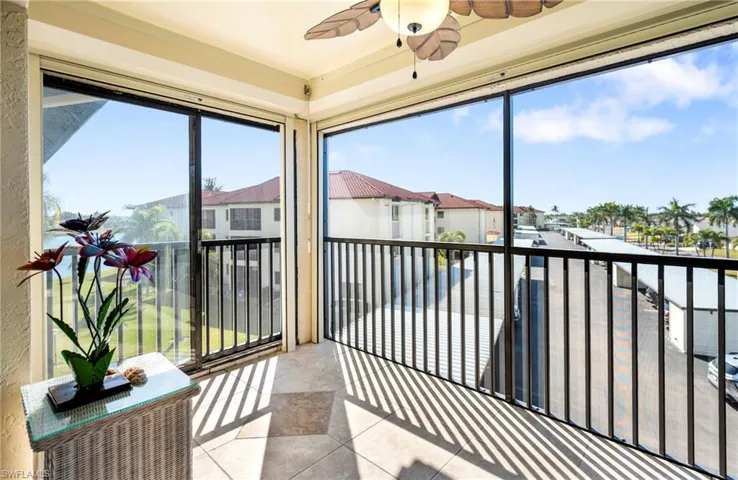 Sunroom / solarium featuring tile patterned flooring and a residential view