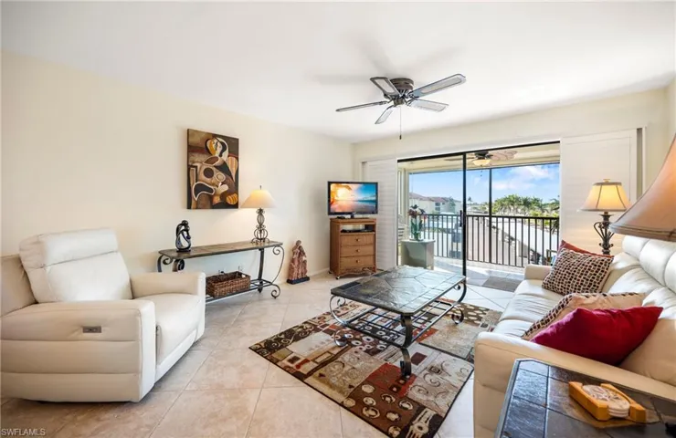 Tiled living area featuring ceiling fan