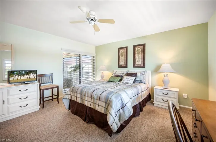 Bedroom featuring ceiling fan and light colored carpet