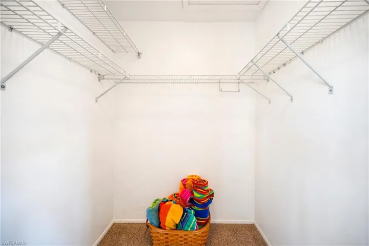 Walk in closet featuring carpet flooring