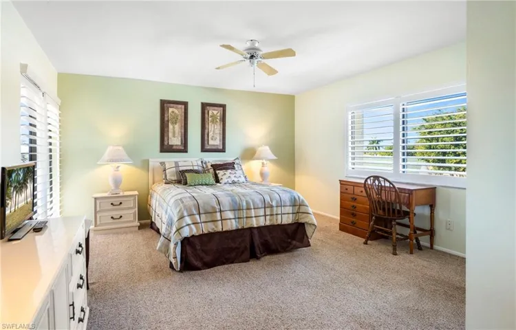 Bedroom featuring light carpet and ceiling fan